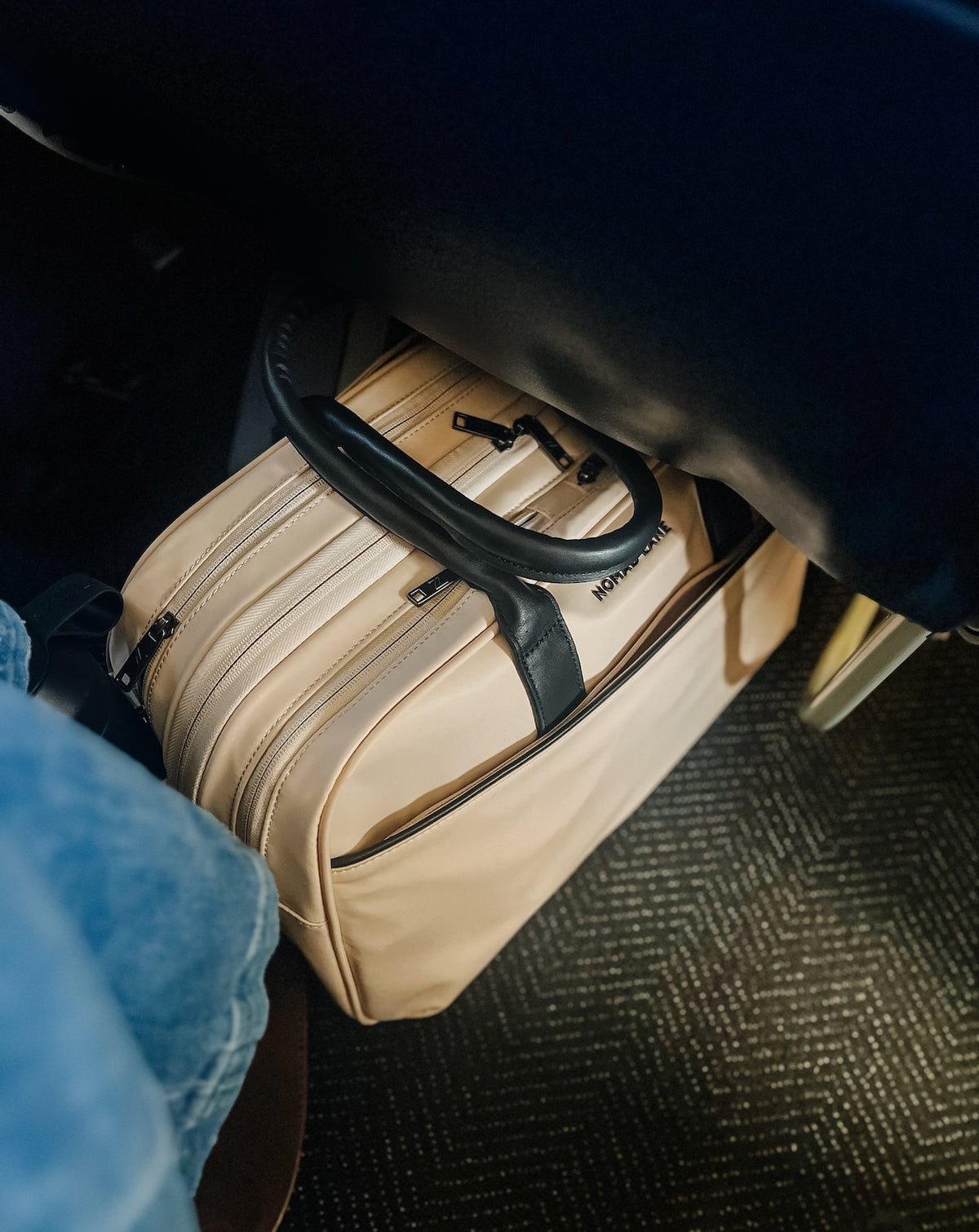 Woman working on laptop in airport lounge with Bento Bag