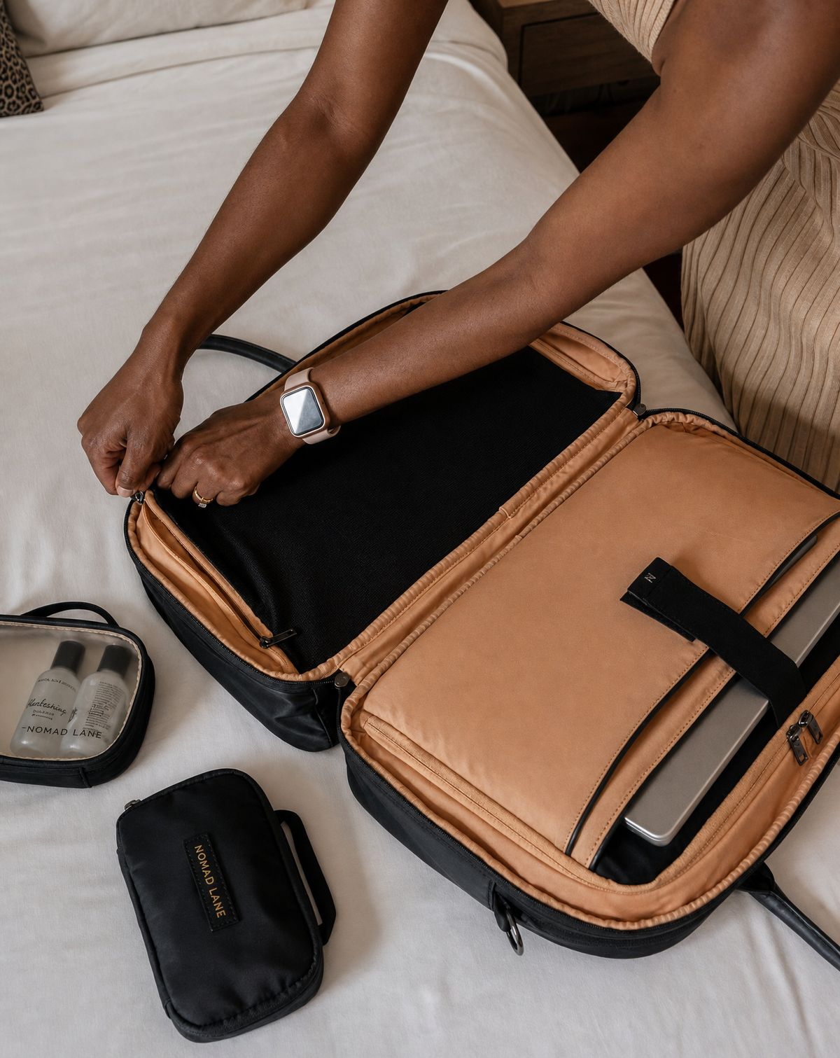 Woman working on laptop in airport lounge with Bento Bag